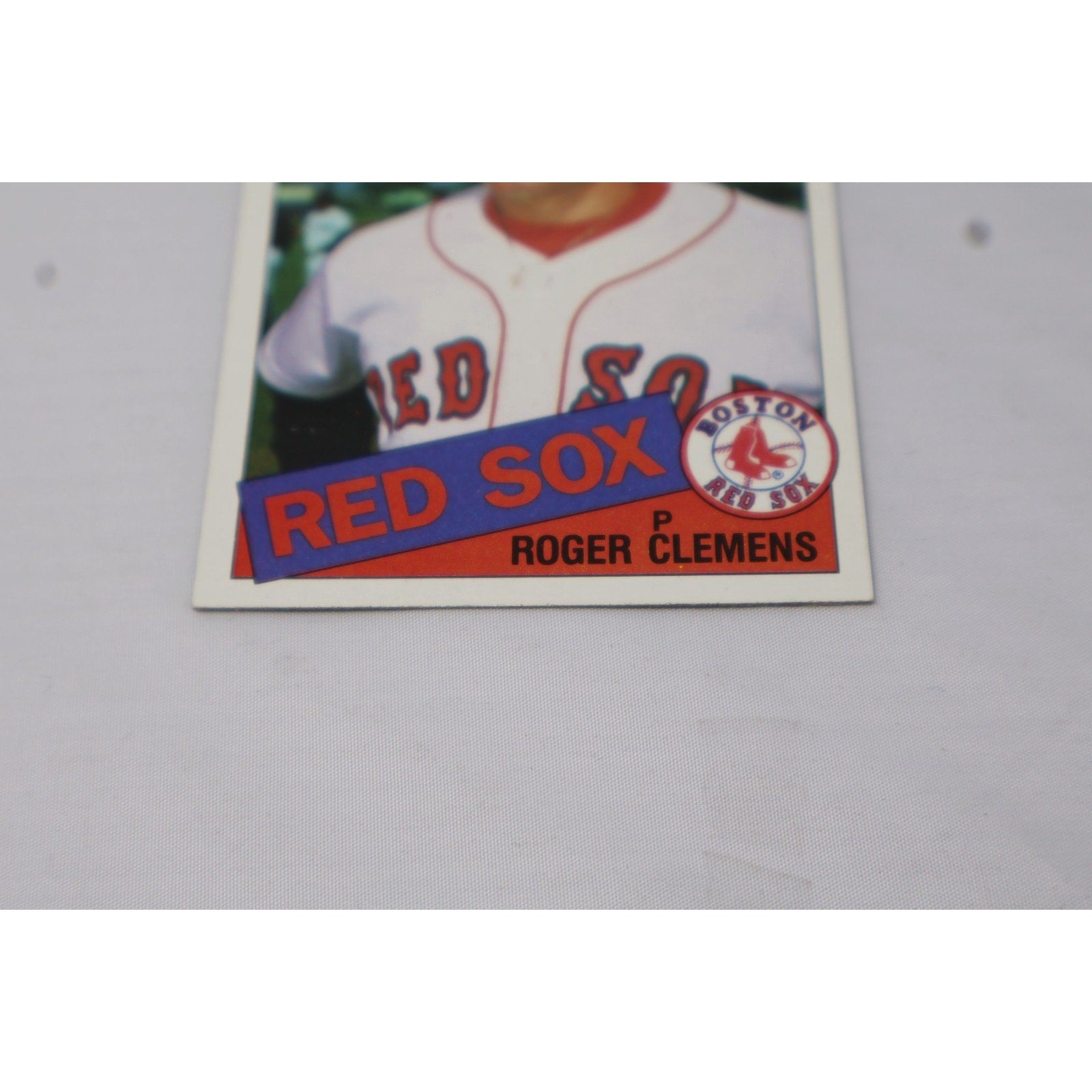 Angled front view of Roger Clemens 1985 Topps rookie card featuring Boston Red Sox team logo