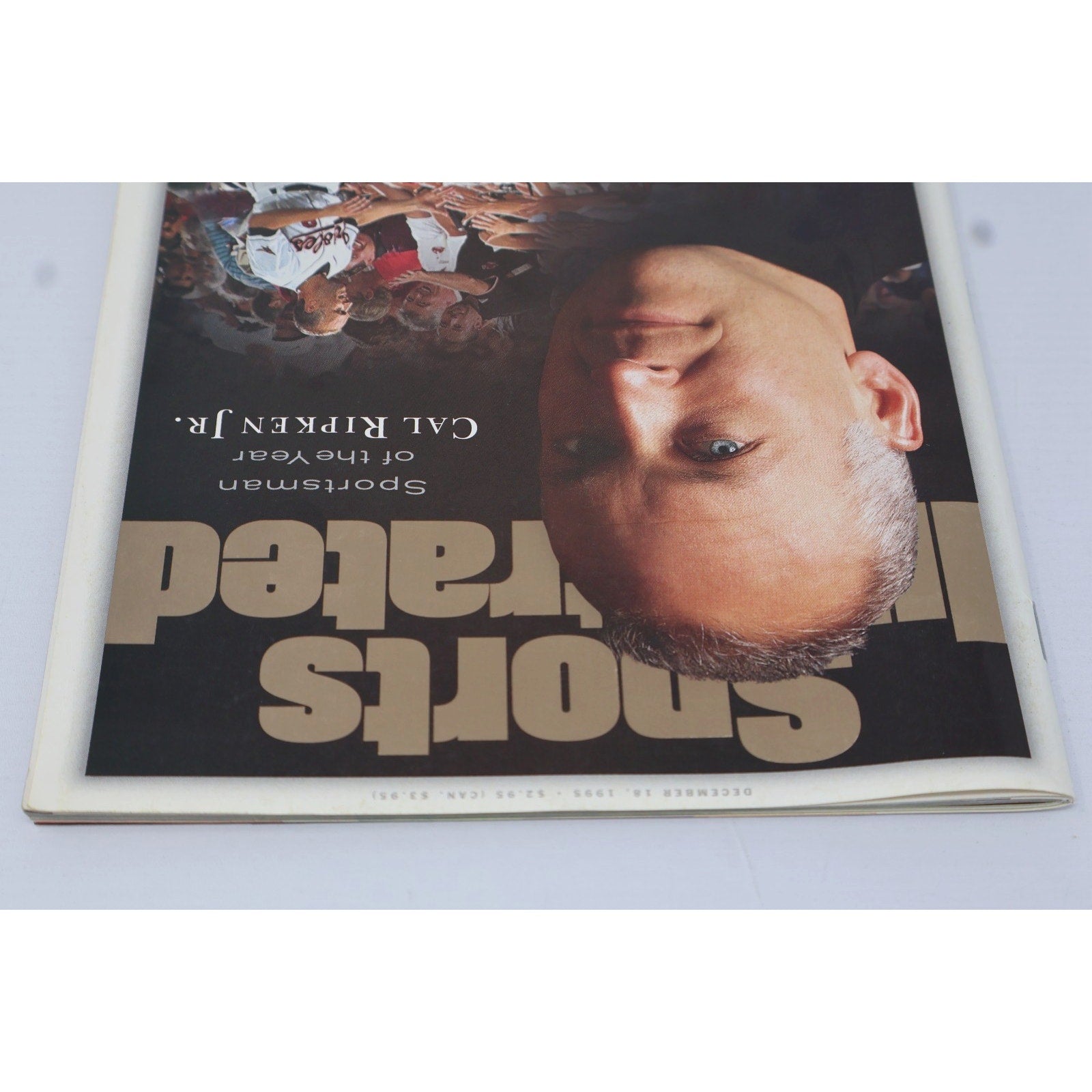 Upside-down view of Sports Illustrated cover featuring Cal Ripken Jr portrait artwork