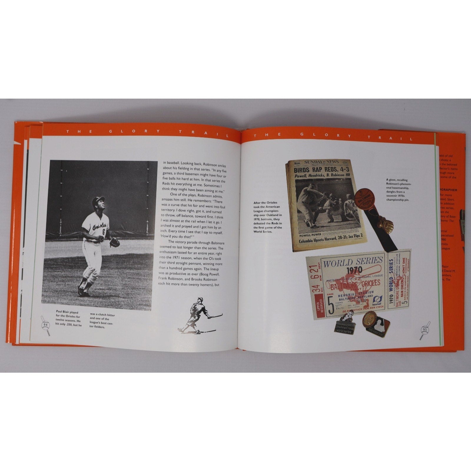 Open interior pages of Baltimore Orioles memorabilia and history book with photos and collectibles