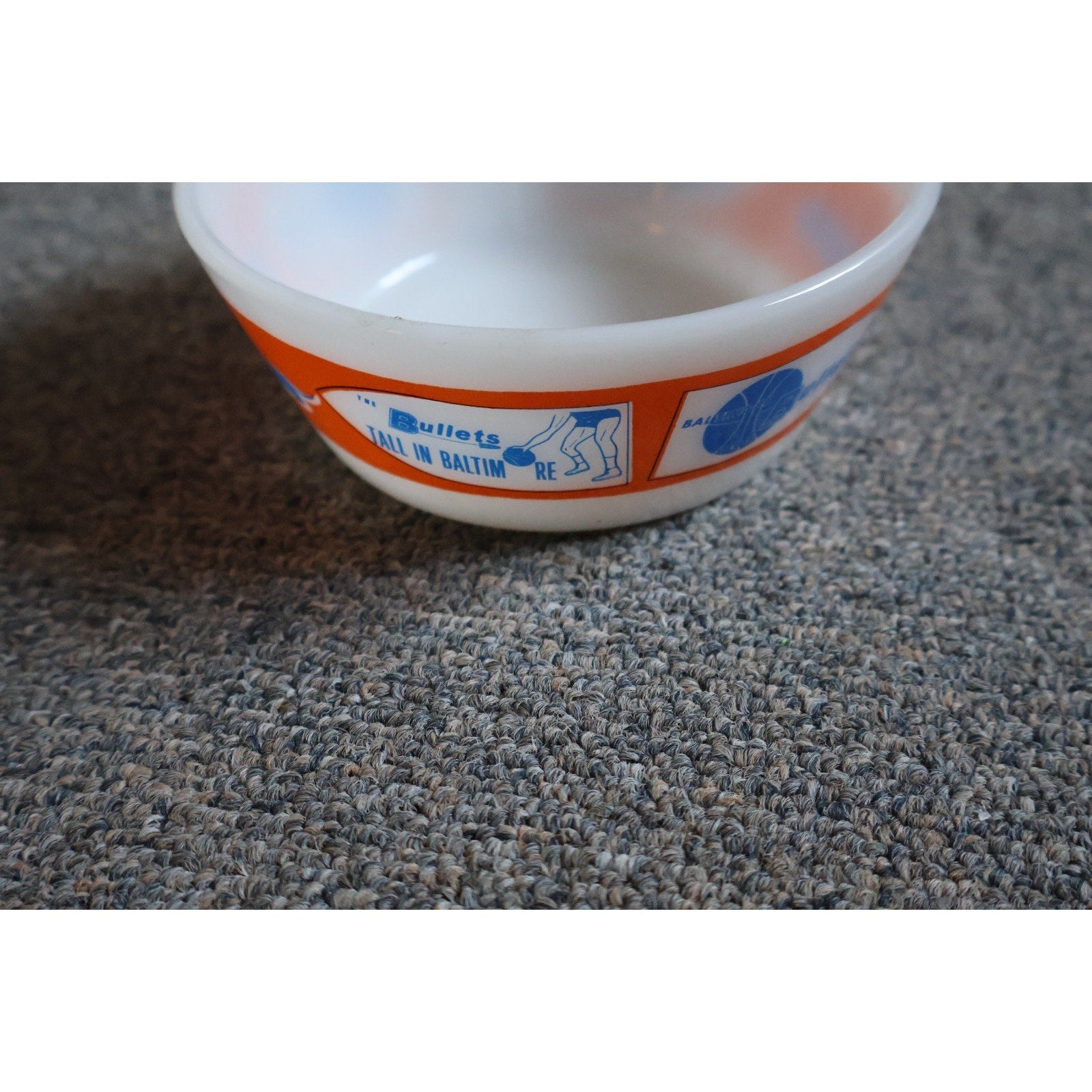 Side angle view of vintage Baltimore Bullets Westfield white glass collectible bowl