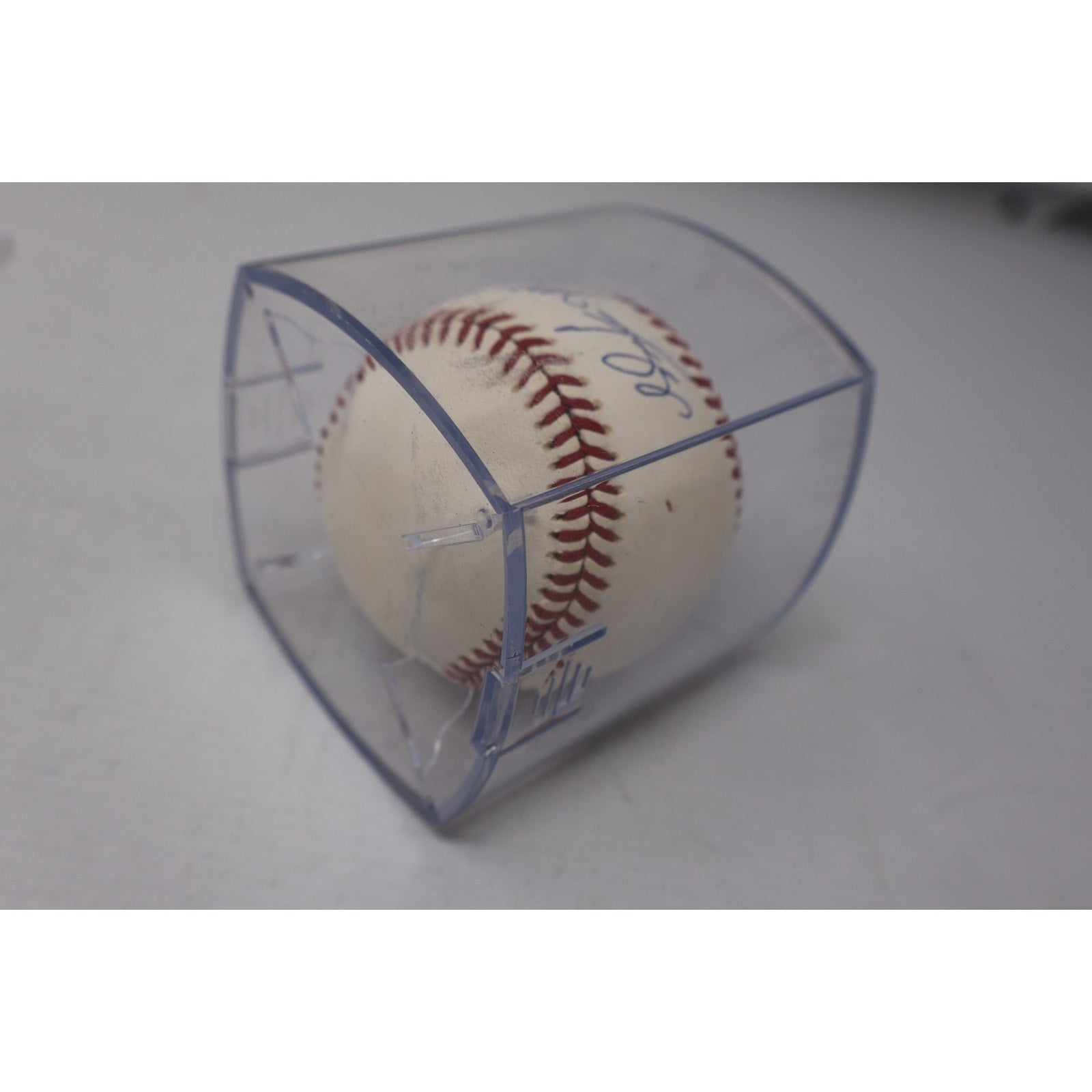 Angled side view of autographed Wade Boggs baseball in display case