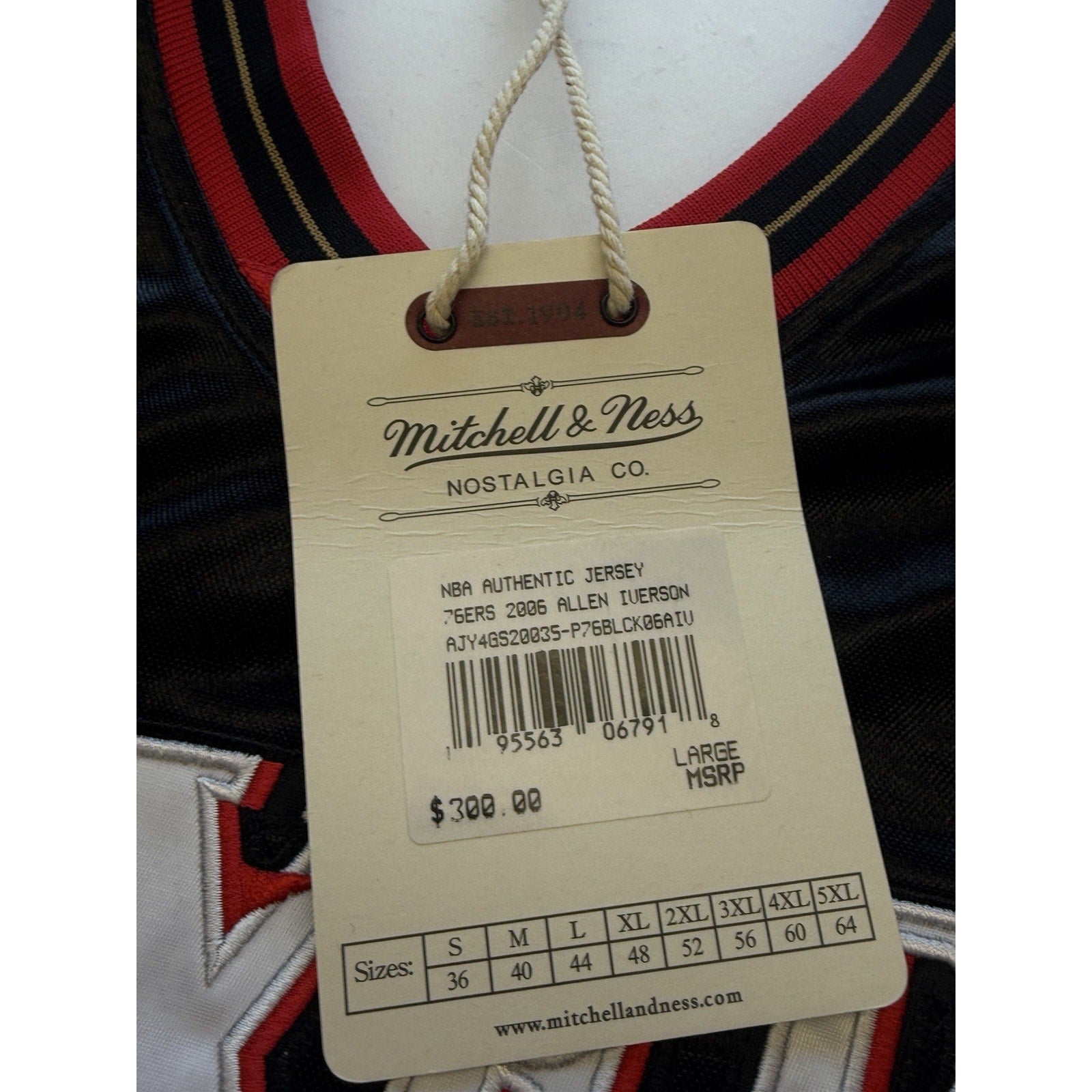 Mitchell & Ness Hardwood Classics authenticity tag attached to Allen Iverson jersey