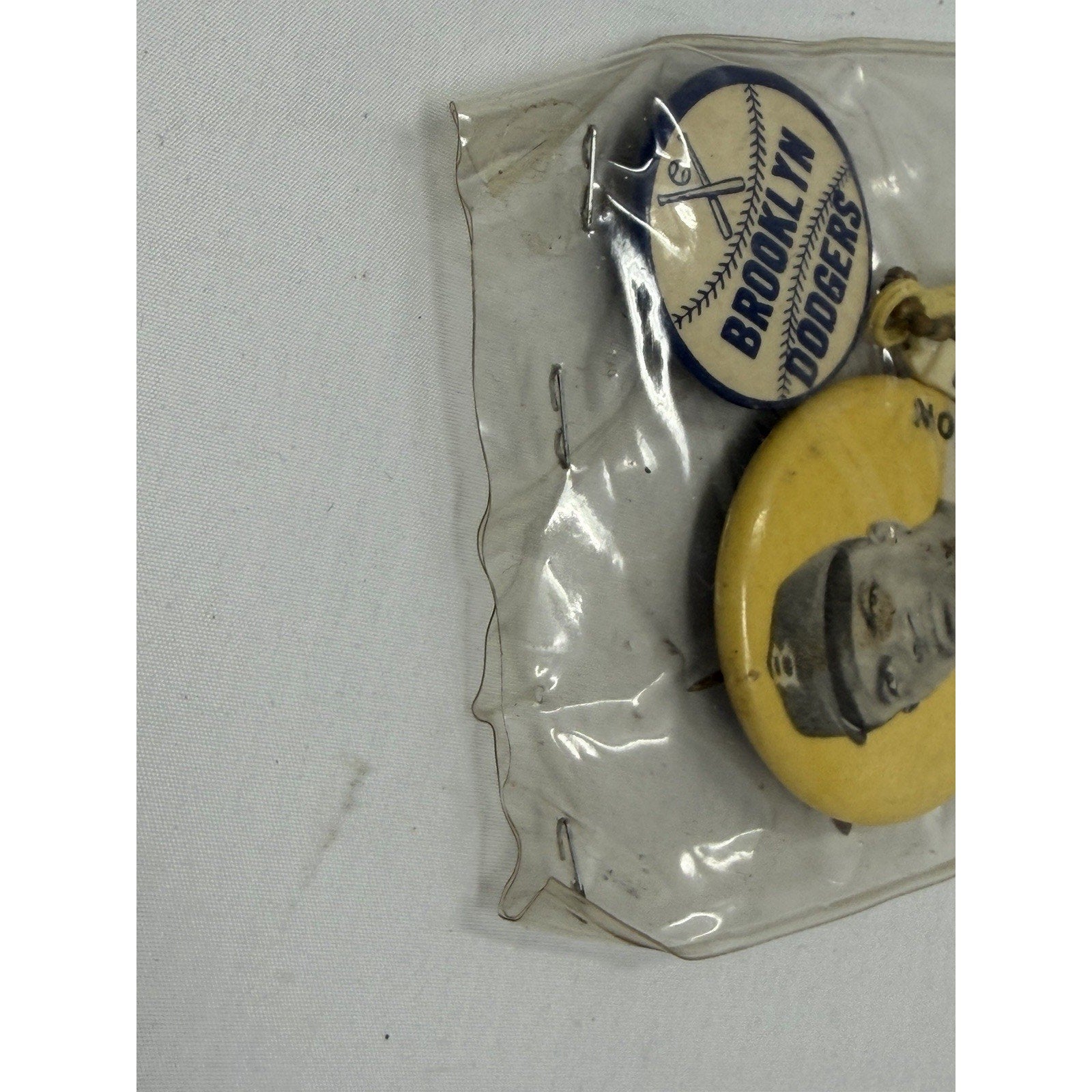 Side angle of sealed Jackie Robinson Brooklyn Dodgers vintage pin set