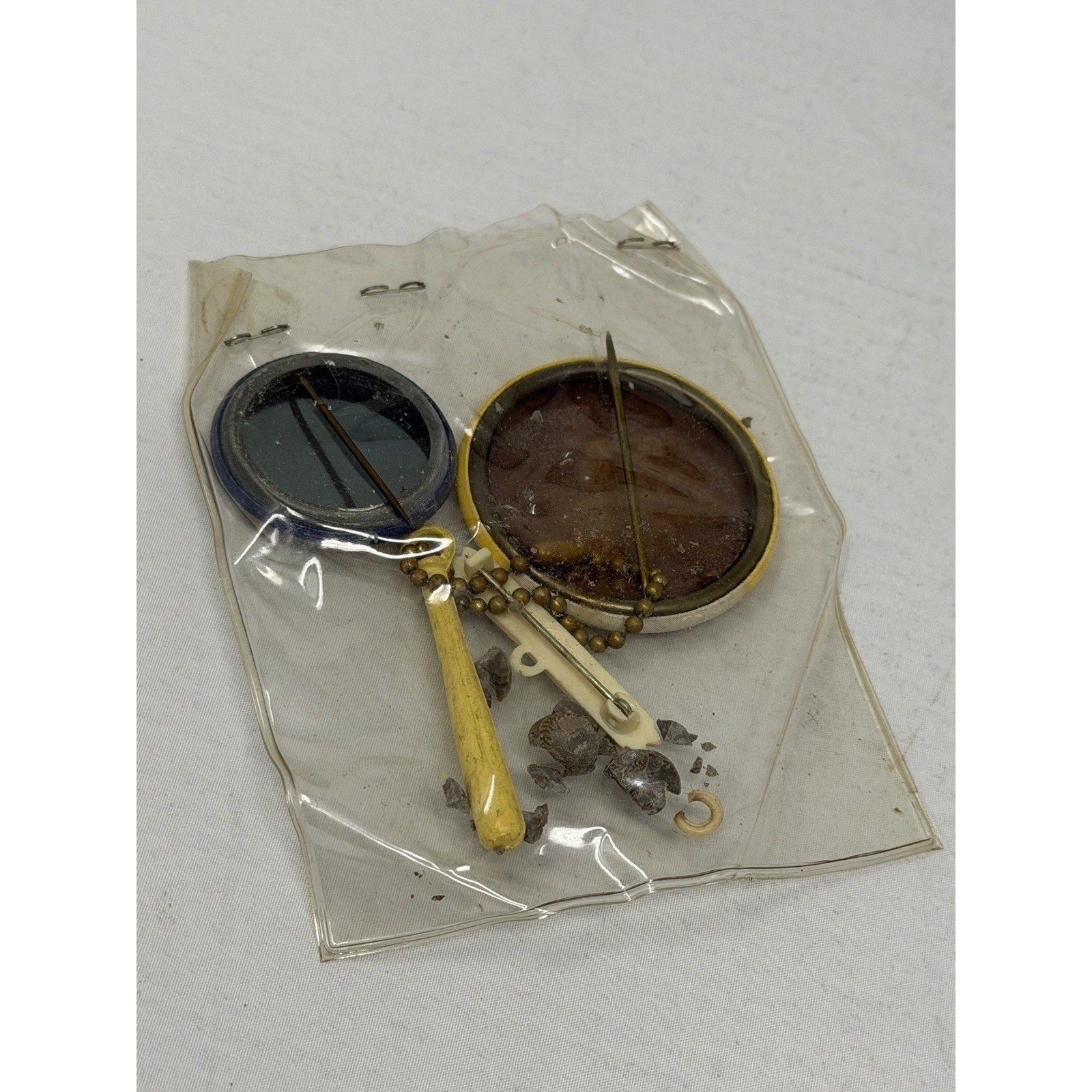Close-up of Jackie Robinson portrait pin and Brooklyn Dodgers souvenir charm