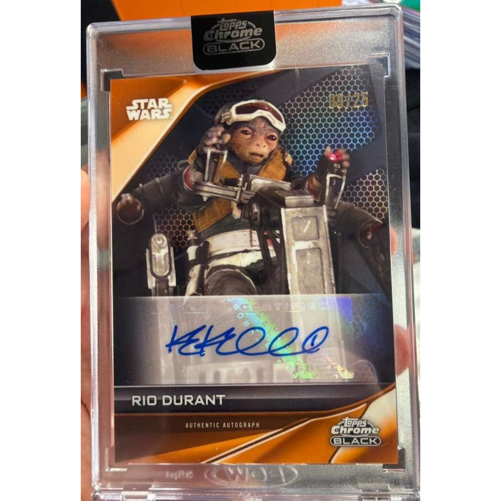 Angled front view of 2025 Topps Chrome Black Star Wars Rio Durant Orange Refractor auto card signed by Katy Kartwheel